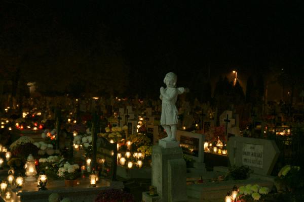 Nocny spacer po cmentarzu w blasku lampionów i księżyca