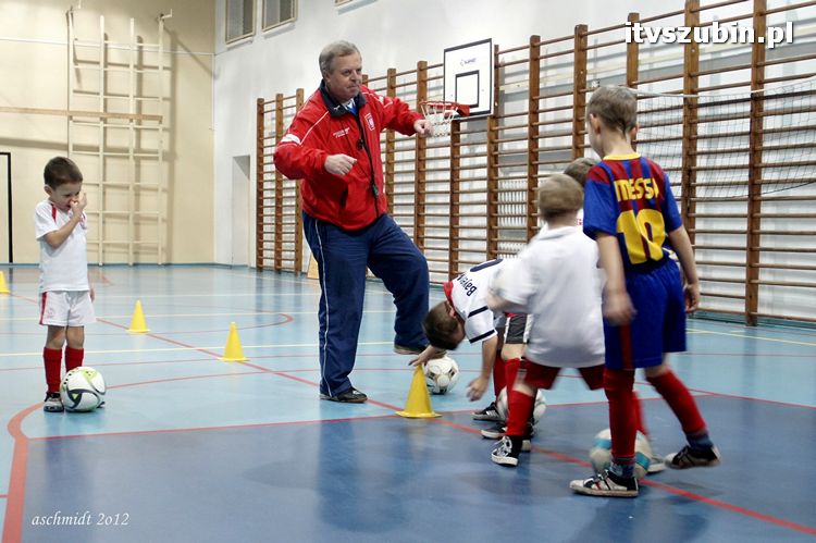 Młodzi piłkarze trenują i zdobywają umiejętności pod czujnym okiem trenera